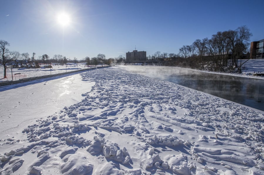 Bitter cold creates icy conditions on the Saint Joseph River, near Howard Park, on Thursday, Jan. 31, 2019, in South Bend, Ind.