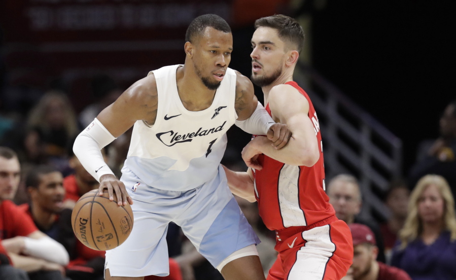 Cleveland Cavaliers’ Rodney Hood, left, drives past Washington Wizards’ Tomas Satoransky, from Czech Republic, in the second half of an NBA basketball game, Tuesday, Jan. 29, 2019, in Cleveland.