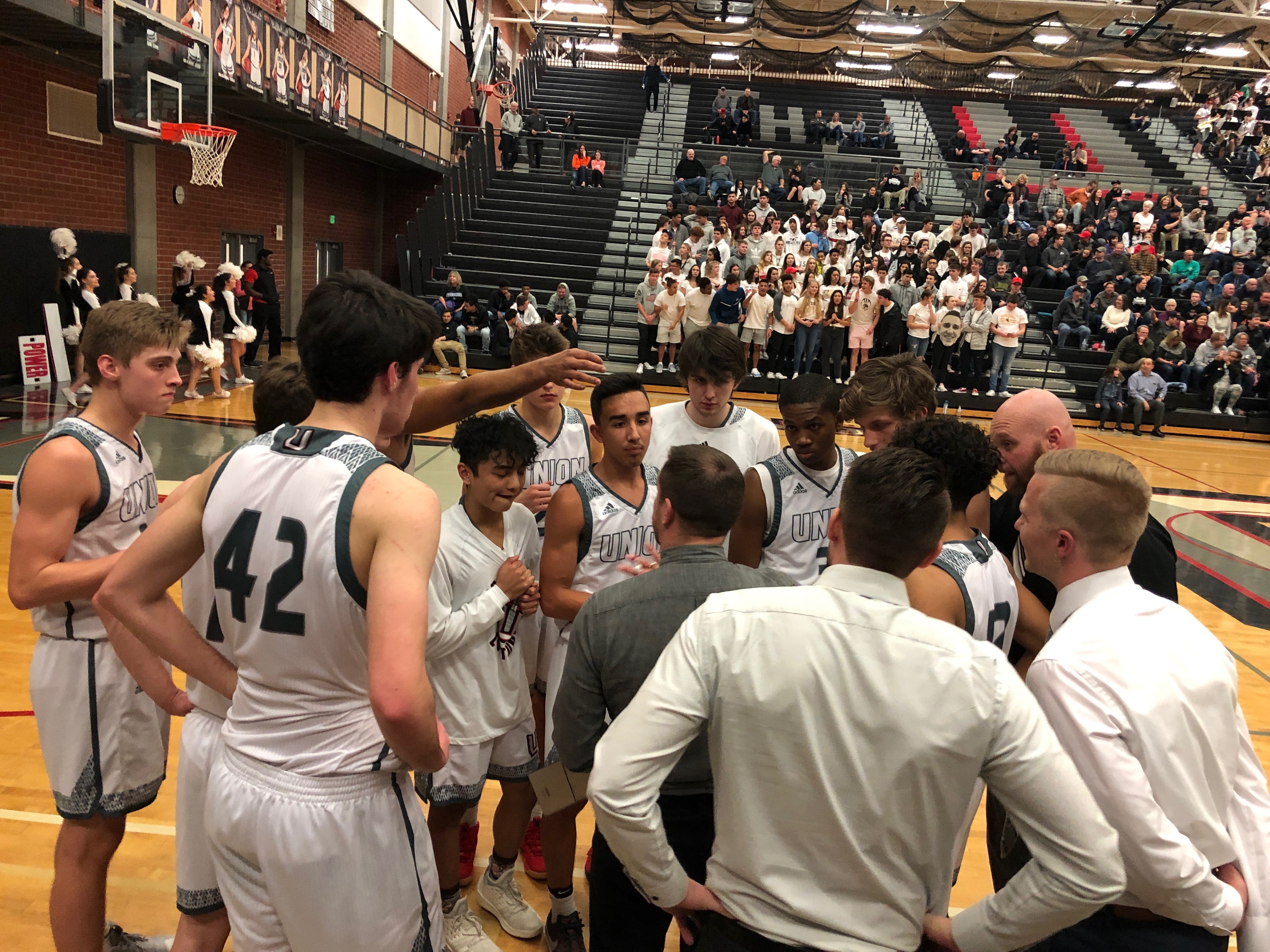 The Union Titans listen to coach Blake Conley in a fourth quarter timeout of a 75-52 win over Sumner in the bi-district playoff on Thursday at Union High School.