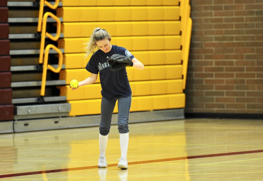 Prairie center fielder Ashley Shelton gathers herself after catching a pop fly during an indoor practice in Prairie High School’s gym.