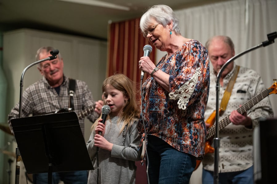 Six-year-old Megan Wilder helps her grandmother, Eilene Laing, sing “You Are My Sunshine” during the biweekly gathering of the Columbia River Old Time Strings at the Minnehaha Grange. Accompanying them are Jerry Jacobs on guitar and Ron Coon on bass. Randy L.