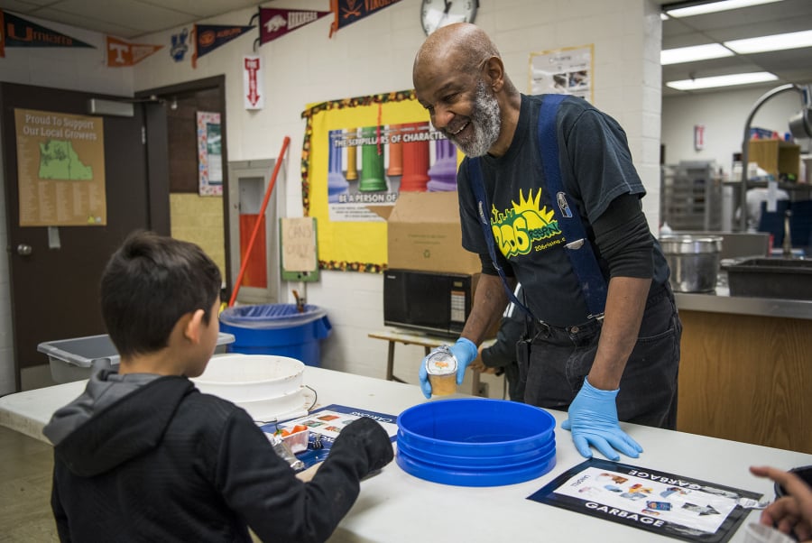 Greg Davis, day custodian, helps students organize their lunch plates for the cafeteria composting system at Martin Luther King Elementary School in Vancouver. Davis has worked for the school district since 1986 and at Martin Luther King Elementary School for 25 years. He has plans to retire shortly after the school makes a big move to a new building by September 2020.