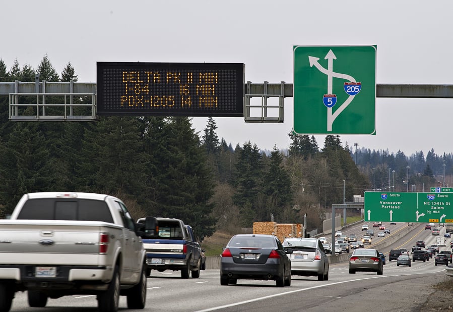 A travel-time sign gives traffic in the southbound lanes of Interstate 5 just south of the Clark County Event Center at the Fairgrounds an estimate for traffic down the road. Signs like these use roadway sensors and radar devices to measure the speed and density of passing traffic, and a computer program uses the information to estimate travel times between two points.