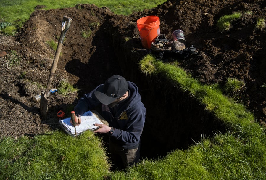 Antonio Delgado, an environmental health specialist with Clark County, tests the soil where a septic system was proposed in 2019 in Ridgefield.