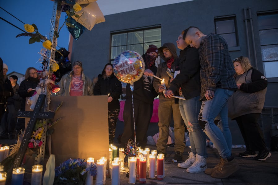 Friends and loved ones of Michael Eugene Pierce gather for an emotional candlelight vigil in his memory Friday evening in downtown Vancouver. About 30 people, many of them homeless, shared memories and jokes about the man Vancouver police officers shot and killed Thursday night.