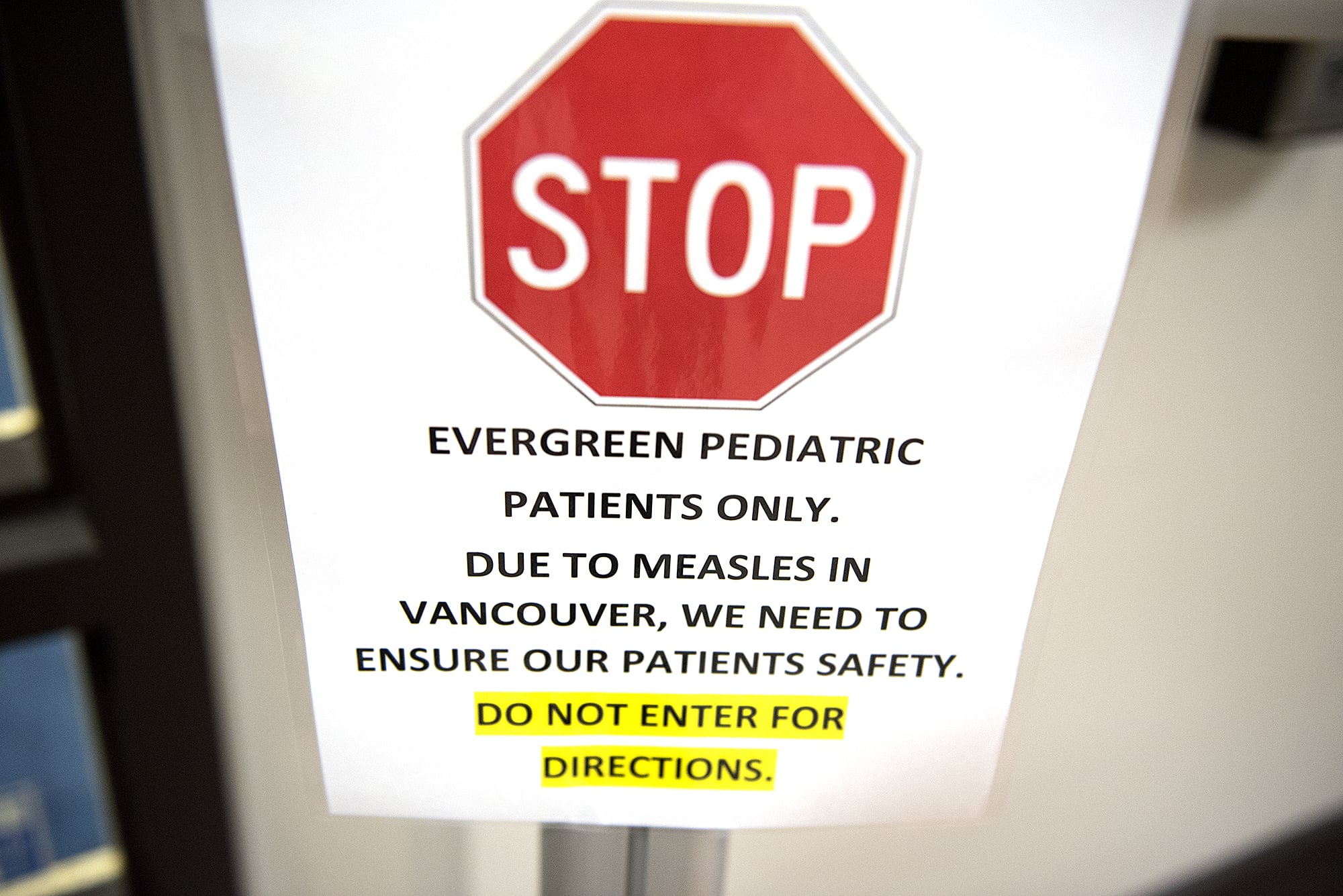 A sign warns visitors to stay away if they have measles at Evergreen Pediatric Clinic.