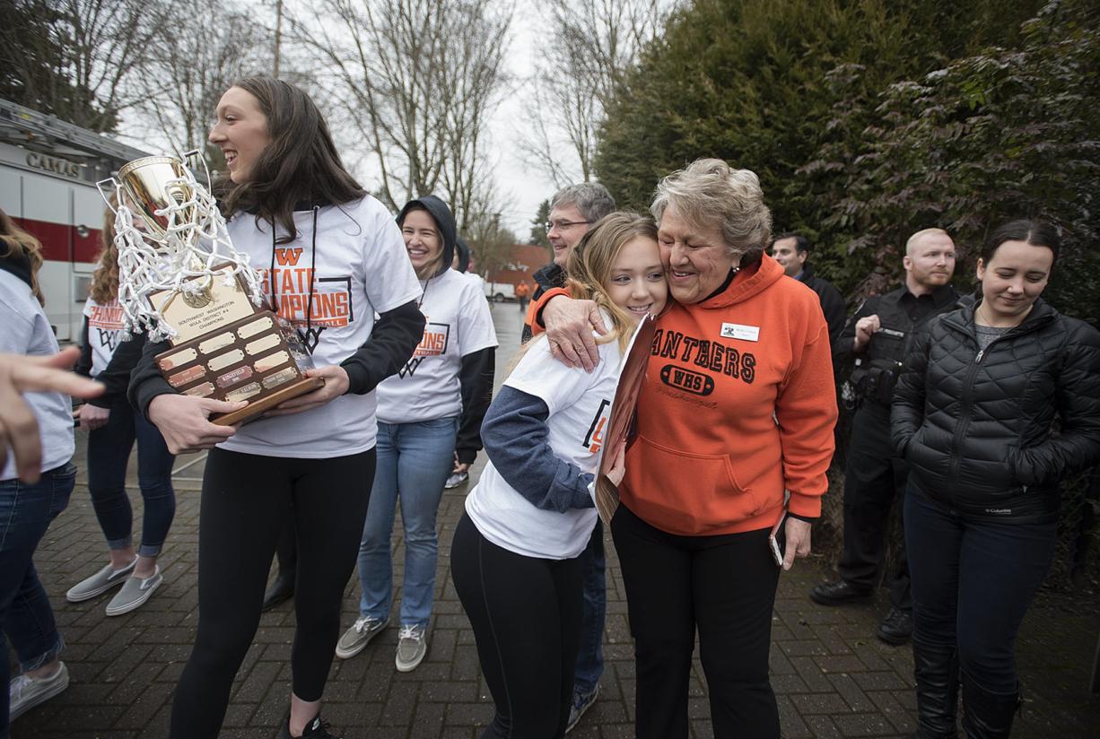 Washougal's Beyonce Bea, from left, celebrates the girls state basketball championship with teammate Kiara Cross and Washougal Mayor Molly Coston at Reflection Plaza in Washougal on Friday morning, March 8, 2019.