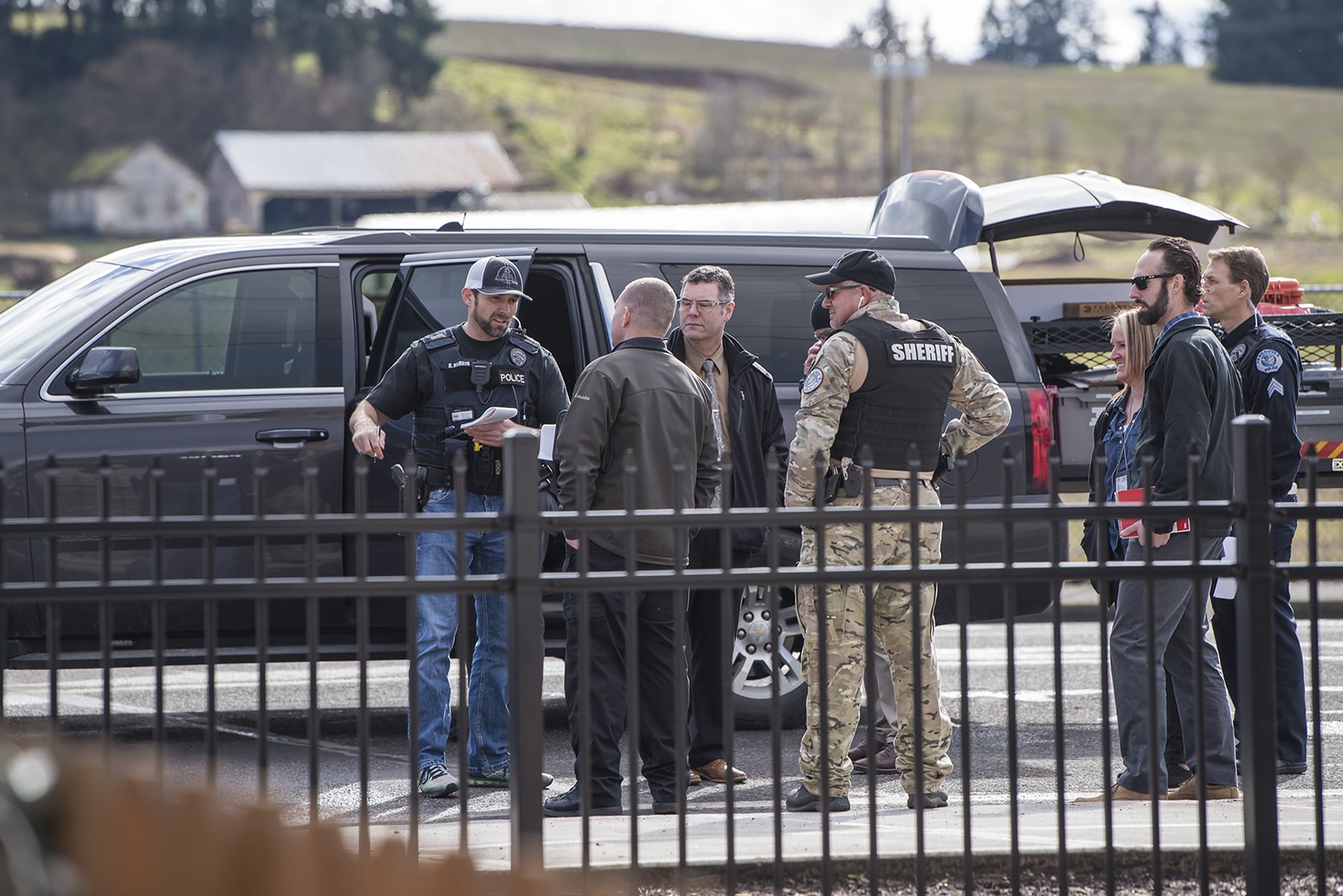 Vancouver Police officers and Clark County Sheriff's Deputies interact at the scene of a police shooting in Hazel Dell on Thursday, March 7, 2019.