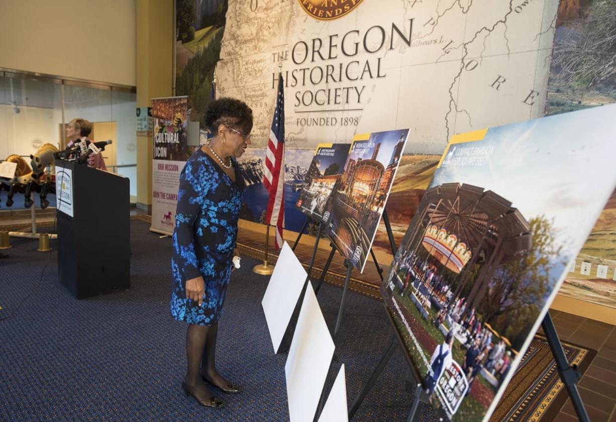 Former Oregon state Sen. Margaret Carter, a longtime fan of the Jantzen Beach Carousel, looks over three proposed design concepts for the return of the carousel during a press conference at the Oregon Historical Society on Monday. Restore Oregon is looking to bring the carousel back to the Portland metro area, and has stated Vancouver is in the running to house the iconic attraction.