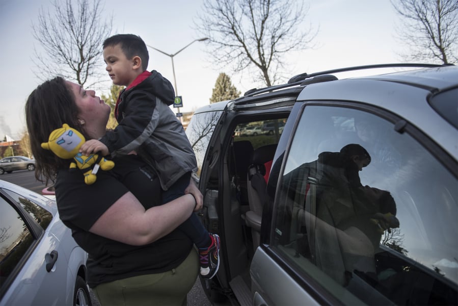 Katherine Shafer, a Clark College student studying addiction counseling, hoists her 3-year-old son Aiden out of the car on their way to Clark College’s on-campus child care center. Two of Shafer’s three sons are enrolled in the program while Shafer completes her degree. Clark College received nearly half a million dollars to pay for tuition and fees for families enrolled at the child care center.