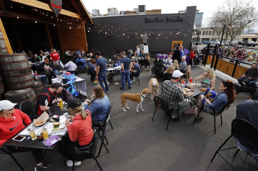 Patrons crowd the patio Saturday at Heathen Brewing Feral Public House during the dog-friendly Yappy Hour, which raised money for the Humane Society for Southwest Washington.