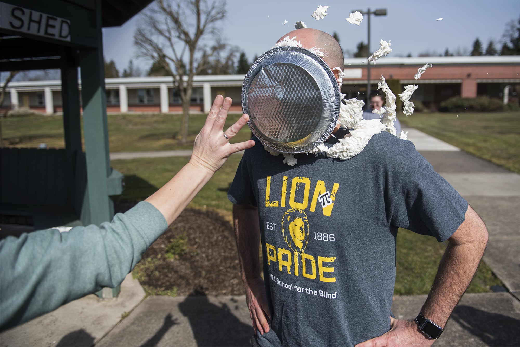 Scott McCallum, superintendent of the Washington State School for the Blind, takes a pie to the face as a reward for students who memorized 50 digits of Pi at the Washington State School for the Blind on Thursday afternoon, March 14, 2019.