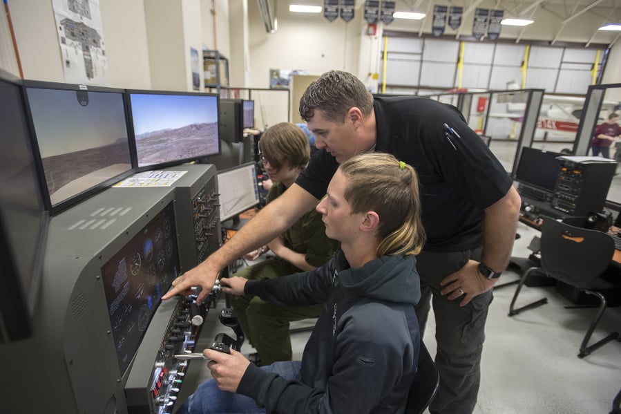 Junior Alex Reif, 17, from left, joins aviation technology instructor Robert Reinebach and Kevin Gamble, 17, also a junior, as they take to the sky in a flight simulator during class at Cascadia Tech Academy. Boeing’s Pilot Outlook for 2018 to 2037 estimates a large shortage of pilots -- 790,000 worldwide, so Reinebach hopes to prepare students for a robust future in the field. ‘All the major airlines are hiring like 500 pilots a year to 1,000 pilots a year,’ he said.