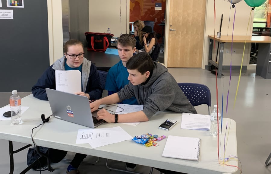 Felida: Skyview High School students, from left, Ella Konency, Ian Baldwin and Benecio Enriquez participate in a coding competition at George Fox University in Newberg, Ore.
