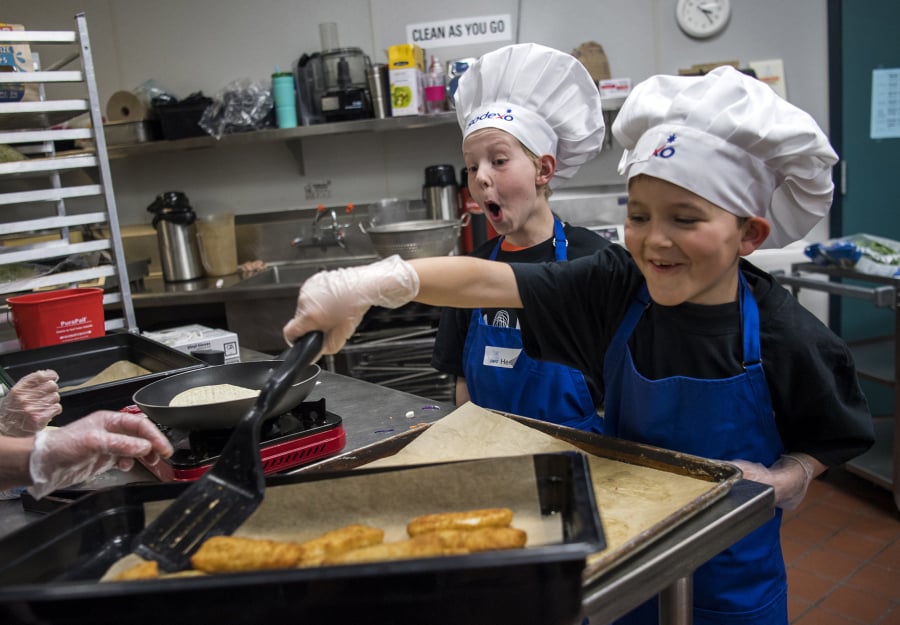Pleasant Valley Primary School third-grader Henry Blickenstaff, left, and Captain Strong Elementary School third-grader Noah Ruotsalainen prepare fish tacos for the annual Sodexo Future Chefs Competition hosted by Battle Ground High School on Thursday. The chef of the winning recipe will go on to a regional competition, and potentially on to the national cook-off.