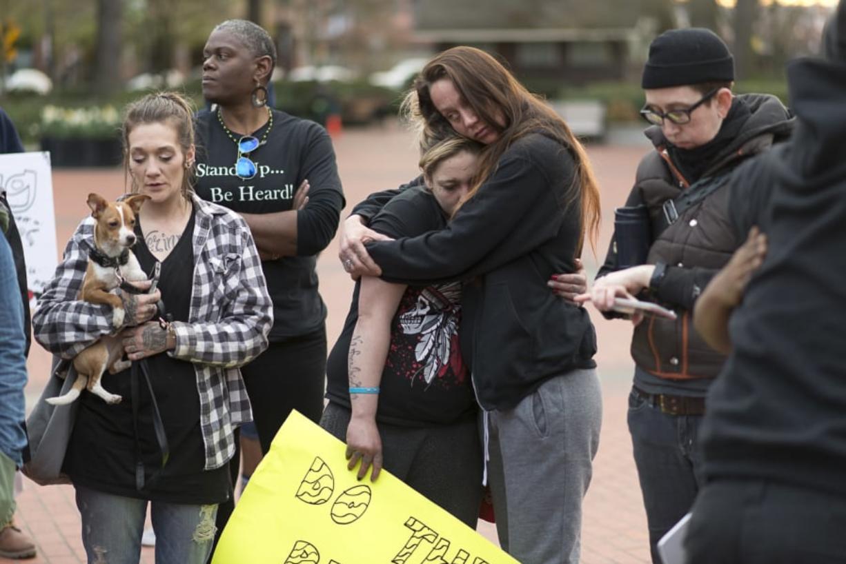 Tiffini Dillard hugs Mollie Wickenhagen during a march Tuesday in downtown Vancouver. Michael Pierce, the father of Wickenhagen’s daughter, was shot and killed Feb. 28 by Vancouver police.