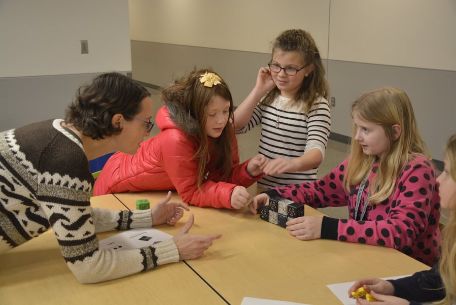 Washougal: Fort Vancouver Regional Library Washougal branch’s Rachael Ries, from left, with Columbia River Gorge Elementary School students, from left, Lauren Byrne, Aubrey Timmons and Bailey Wright in the school’s Coding Club, where students recently used robot blocks to learn about critical thinking.