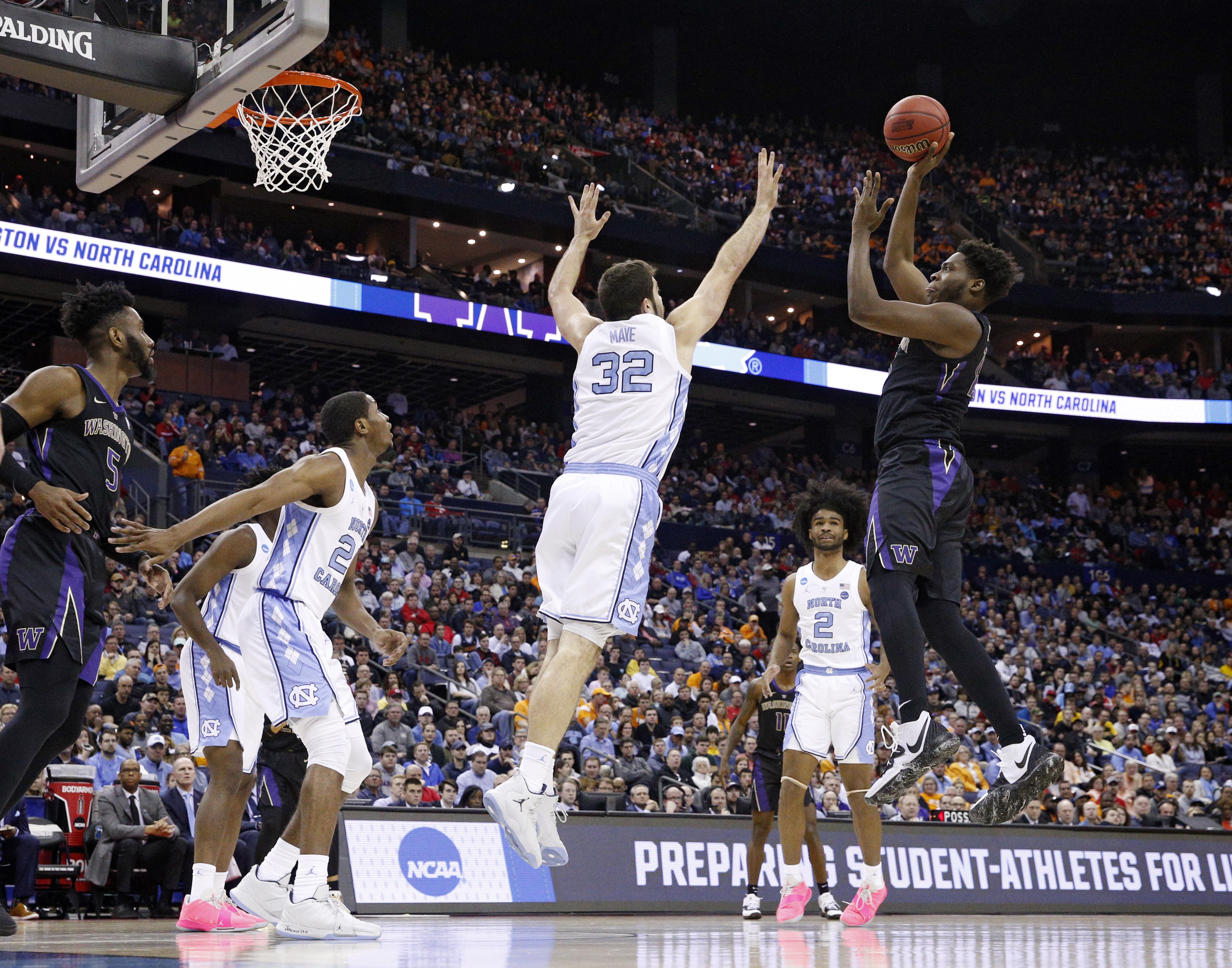 Washington's Noah Dickerson, right, shoots over North Carolina's Luke Maye in the first half during a second round men's college basketball game in the NCAA Tournament in Columbus, Ohio, Sunday, March 24, 2019.