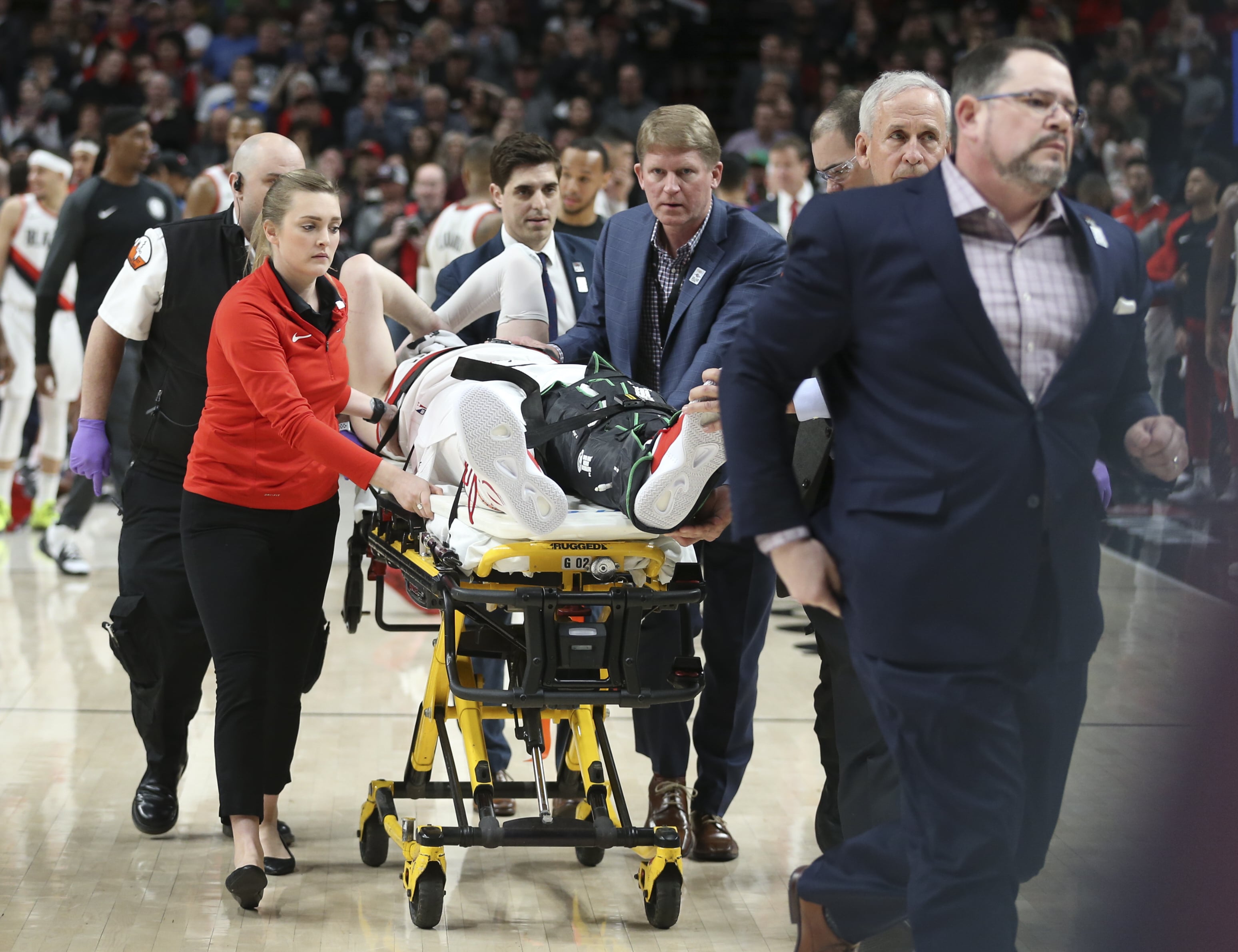 Portland Trail Blazers center Jusuf Nurkic, center, was injured and left the court on a stretcher as the Blazers beat the Brooklyn Nets in double overtime, 148-144, during an NBA basketball game in Portland, Ore., Monday, March 25, 2019. (AP Photo/Randy L.