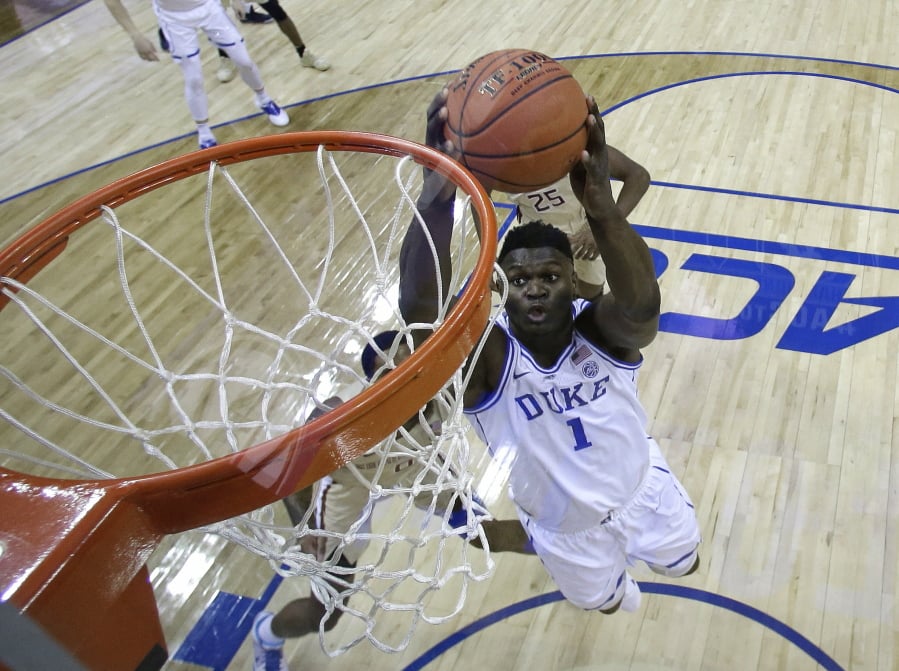 Duke’s Zion Williamson (1) goes up to dunk against Florida State during the first half of the NCAA college basketball championship game of the Atlantic Coast Conference tournament in Charlotte, N.C., Saturday, March 16, 2019.