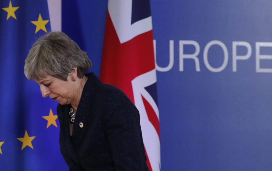 British Prime Minister Theresa May leaves after addressing a media conference at an EU summit in Brussels, Friday.