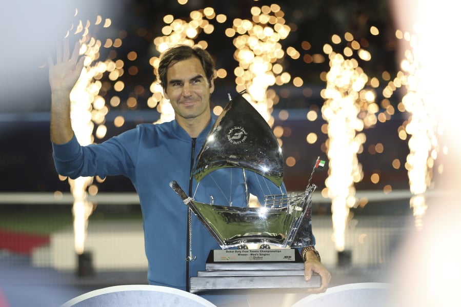 Roger Federer of Switzerland holds his trophy after winning the final match at the Dubai Duty Free Tennis Championship against Stefanos Tsitsipas of Greece during, in Dubai, United Arab Emirates, Saturday, March 2, 2019.