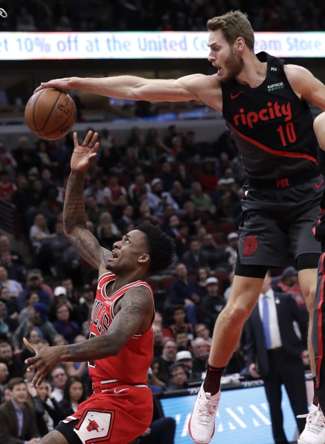 Portland Trail Blazers forward Jake Layman, right, blocks a shot by Chicago Bulls guard Antonio Blakeney during the first half of an NBA basketball game Wednesday, March 27, 2019, in Chicago. (AP Photo/Nam Y.