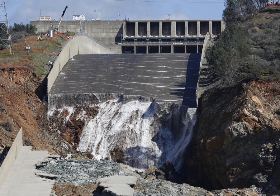FILE - In this Feb. 28, 2017, file photo, water flows down the Oroville Dam’s crippled spillway in Oroville, Calif. The federal government has rejected $306 million in reimbursements for California’s repair of the nation’s tallest dam, a state agency said Friday, March 8, 2019. That’s just less than half of what California has so far requested from the Federal Emergency Management Agency to repair the Oroville Dam. FEMA has approved $333 million. State water officials put total reconstruction costs at $1.1 billion.