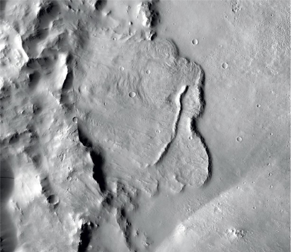 This undated photo provided by the European Space Agency, ESA, shows the surface of the Mars. Scientists say images of Martian craters taken by European and American space probes show there likely once was a planet-wide system of underground lakes.