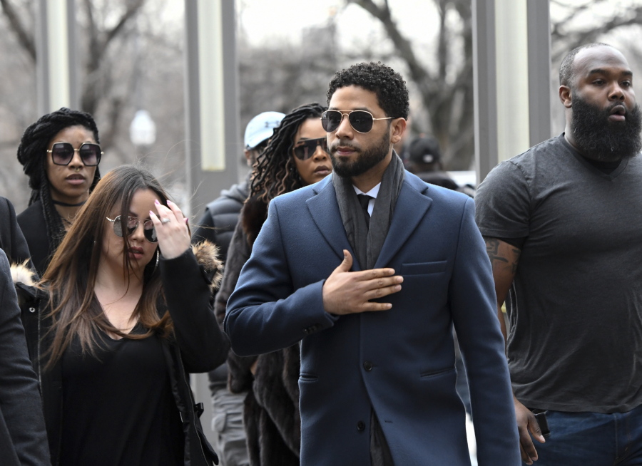 Empire actor Jussie Smollett, center, arrives at the Leighton Criminal Court Building for his hearing on Thursday, March 14, 2019, in Chicago. Smollett is accused of lying to police about being the victim of a racist and homophobic attack by two men on Jan. 29 in downtown Chicago.