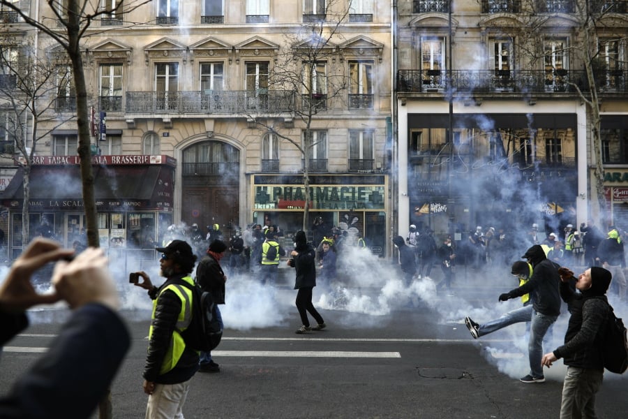 Teargas is used to disperse demonstrators during minor clashes with police in Paris, Saturday, March 23, 2019. The French government vowed to strengthen security as yellow vest protesters stage a 19th round of demonstrations, in an effort to avoid a repeat of last week’s riots in Paris.