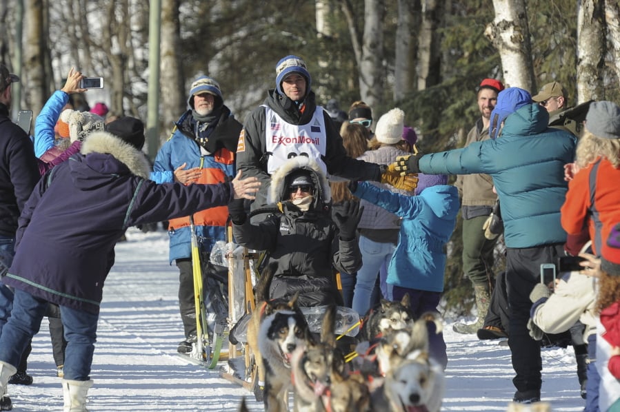 Defending Iditarod champion Joar Lefseth Ulsom, of Norway, greets fans on the trail during the ceremonial start of the Iditarod Trail Sled Dog Race Saturday, March 2, 2019 in Anchorage, Alaska.