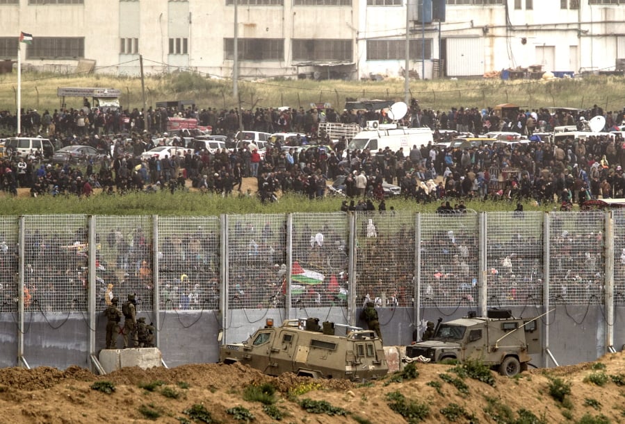 Israeli soldiers take up positions on the Israel-Gaza border Saturday during a protest by Palestinians.