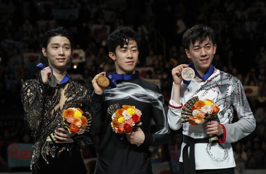 From left, Japan’s Yuzuru Hanyu, Nathan Chen from the U.S. and Vincent Zhou from the U.S. display their silver, gold and bronze medals respectively during the men’s free skating routine during the ISU World Figure Skating Championships at Saitama Super Arena in Saitama, north of Tokyo, Saturday, March 23, 2019.