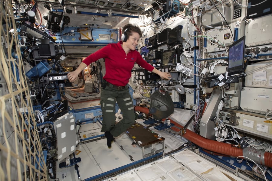 In this Jan. 18, 2019 photo made available by NASA, Flight Engineer Anne McClain looks at a laptop computer screen inside the U.S. Destiny laboratory module of the International Space Station. McClain was supposed to participate in a spacewalk Friday, March 29, 2019 with newly arrived Christina Koch. But McClain pulled herself from the lineup because there’s not enough time to get two mediums suits ready. Koch will go out with a male crewmate.