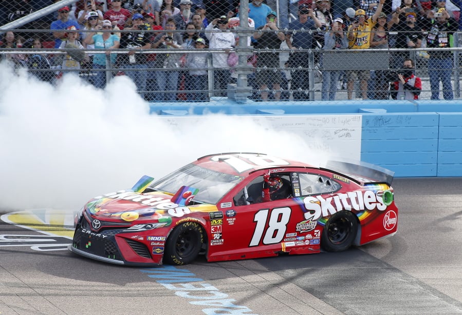 Kyle Busch does a burnout in celebration of winning the NASCAR Cup Series auto race at ISM Raceway, Sunday, March 10, 2019, in Avondale, Ariz.