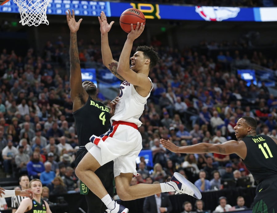Gonzaga forward Brandon Clarke, center, goes to the basket as Baylor’s Mario Kegler (4) and Mark Vital (11) defend during the second half of a second-round game in the NCAA men’s college basketball tournament Saturday, March 23, 2019, in Salt Lake City.