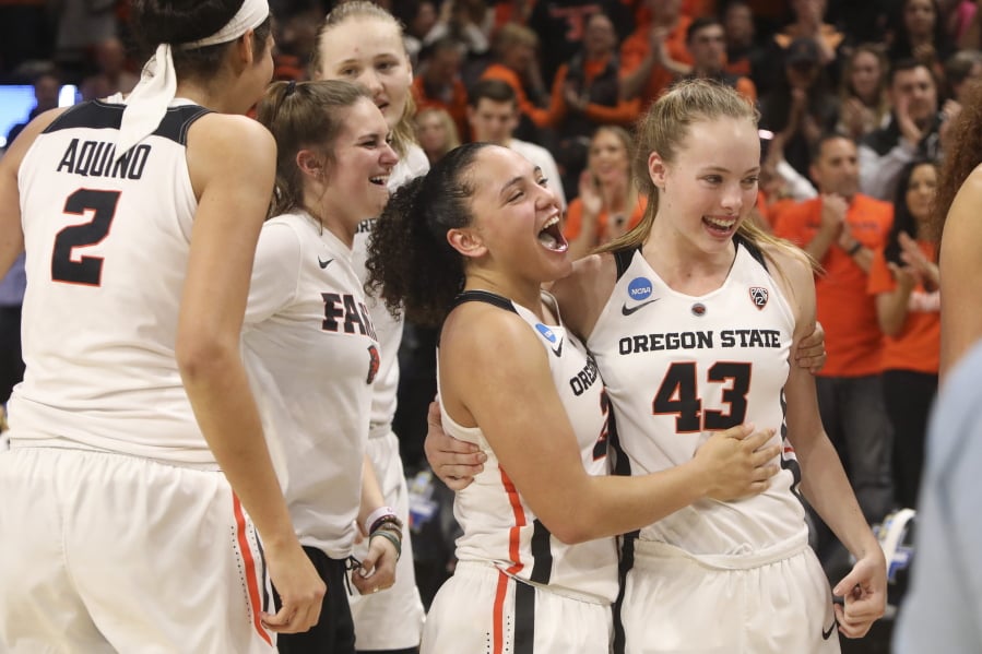 Oregon State’s Andrea Aquino, Kat Tudor, Joanna Grymek, Destiny Slocum and Jasmine Simmons, from left, celebrate the team’s 76-70 win over Gonzaga in a second-round game of the NCAA women’s college basketball tournament in Corvallis, Ore., Monday, March 25, 2019.