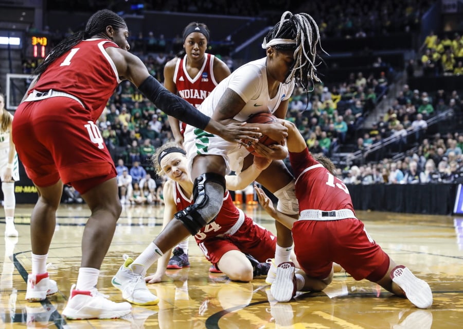Oregon forward Ruthy Hebard (24), fights for a loose ball against Indiana guard Jaelynn Penn (13), during a second-round game of the NCAA women’s college basketball tournament Sunday, March 24, 2019, in Eugene, Ore.