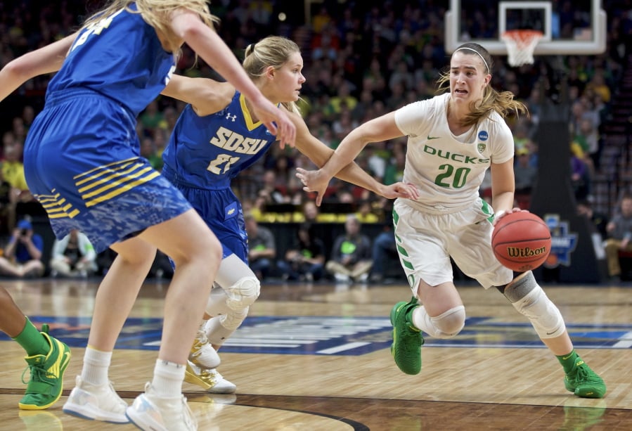 Oregon guard Sabrina Ionescu, right, drives to the basket past South Dakota State guard Tylee Irwin during the first half of a regional semifinal in the NCAA women’s college basketball tournament Friday, March 29, 2019, in Portland, Ore.