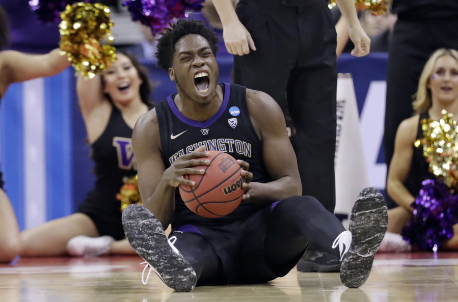Washington’s Noah Dickerson (15) reacts after getting possession of the ball against Utah State in the first half during a first round men’s college basketball game in the NCAA Tournament in Columbus, Ohio, Friday, March 22, 2019.