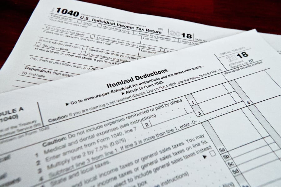 This Feb. 13, 2019, shows multiple forms printed from the Internal Revenue Service web page that are used for 2018 U.S. federal tax returns in Zelienople, Pa. For taxpayers who itemize, the 2 percent miscellaneous itemized deduction was a handy catchall bucket for expenses such as investment fees and expenses and tax-preparation fees. It wasn’t easy to qualify for this deduction, your expenses had to top 2 percent of your adjusted gross income before you could claim them, but it was a nice option to have.
