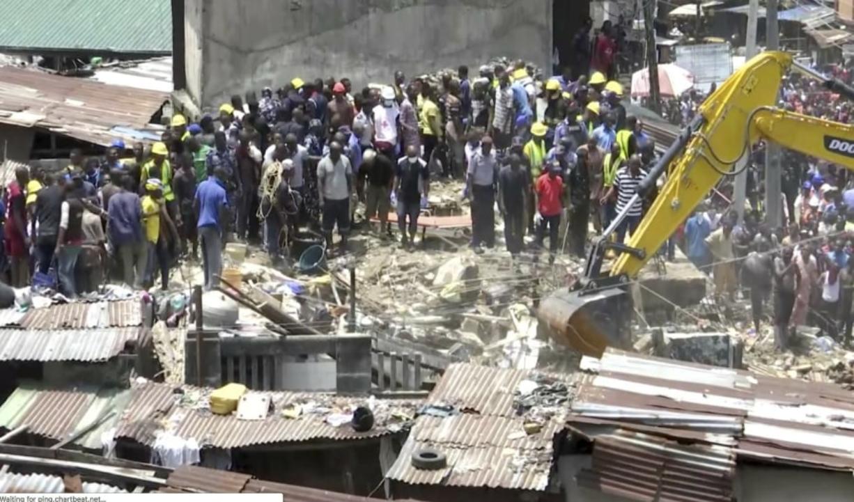 In this image taken from video rescue workers and emergency teams work at the scene of a building collapse in Lagos, Nigeria, Wednesday March 13, 2019. There was no immediate official word on numbers of casualties.