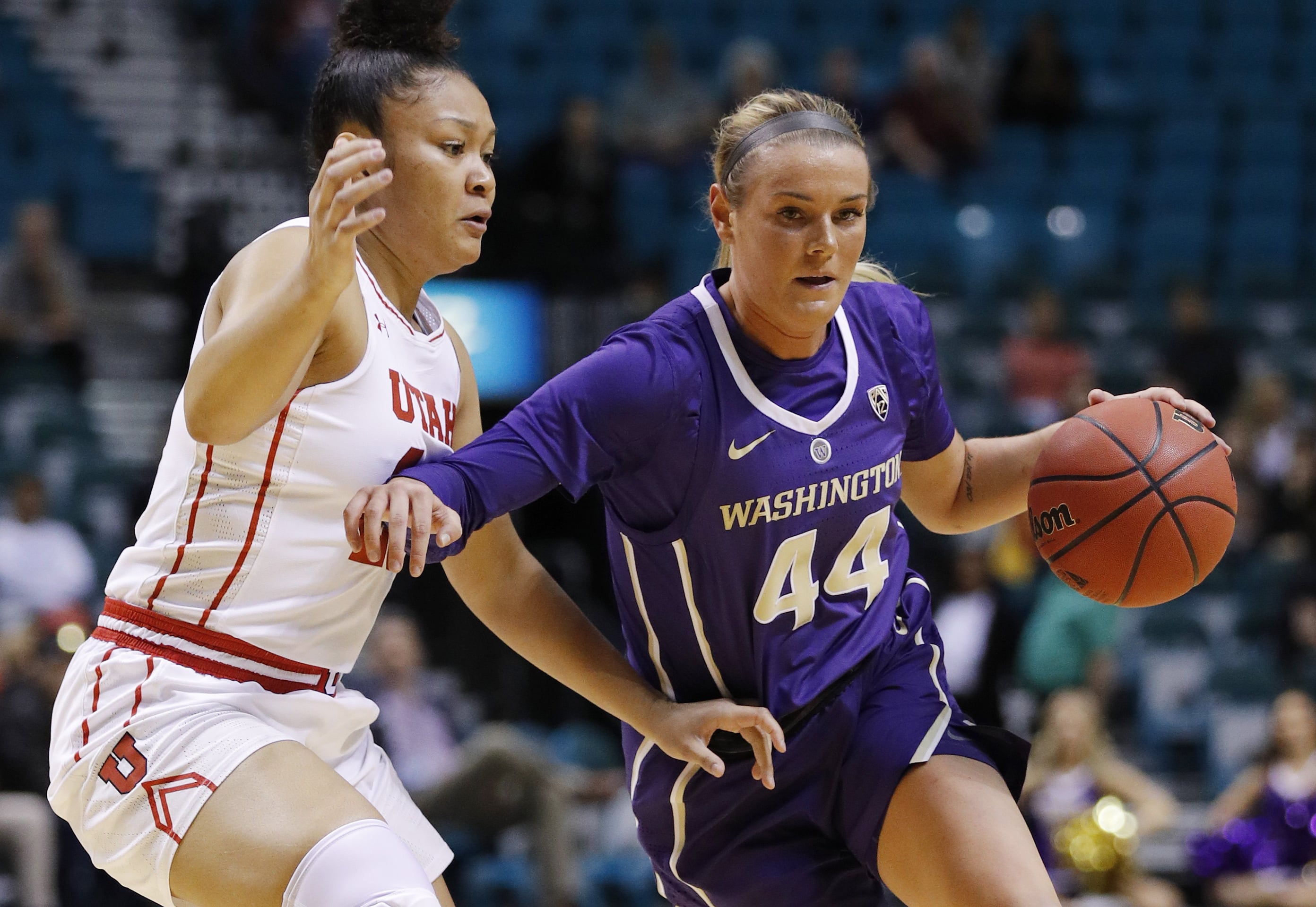Washington's Missy Peterson drives around Utah's Sarah Porter during the first half of an NCAA college basketball game at the Pac-12 women's tournament Thursday, March 7, 2019, in Las Vegas.