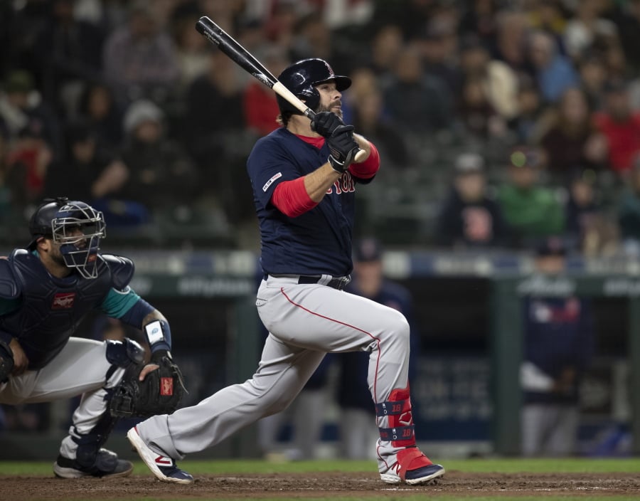 The Boston Red Sox’s Mitch Moreland watches a three-run home run off Seattle Mariners relief pitcher Hunter Strickland during the ninth inning of a baseball game Friday, March 29, 2019, in Seattle.