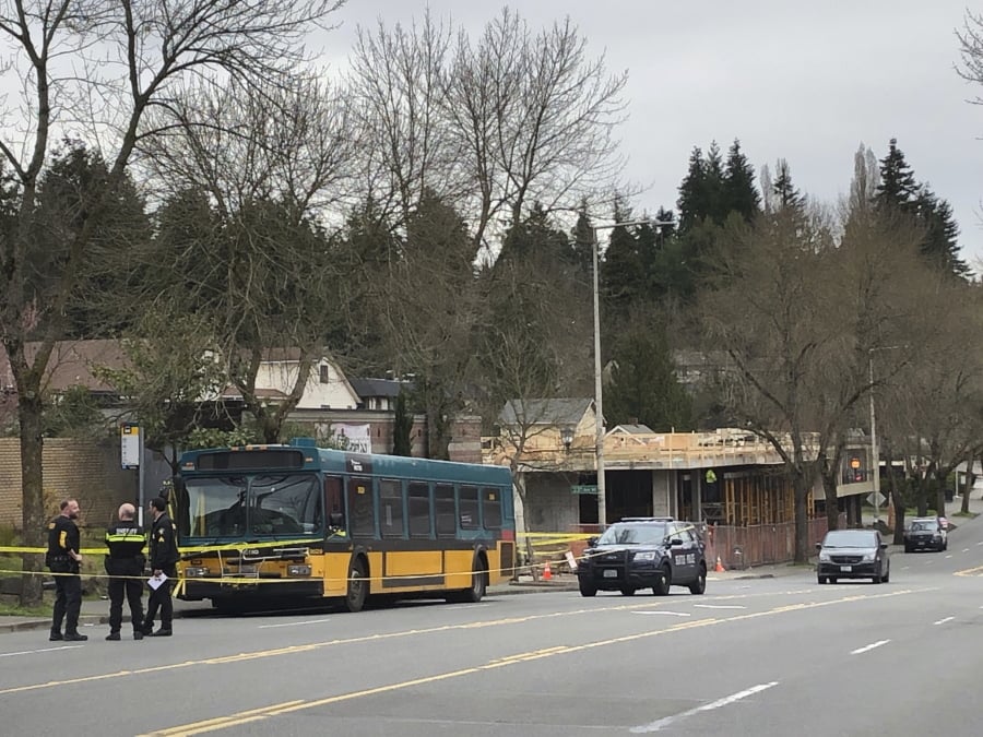 Investigators work at the scene of a shooting in Seattle on Wednesday, March 27, 2019.