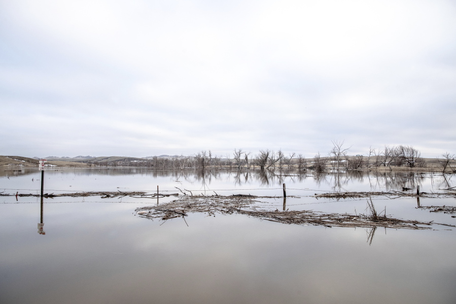 In this Monday, March 25, 2019 photo, standing water pools in a field near Loneman, S.D., on the Pine Ridge Indian Reservation, following spring flooding.