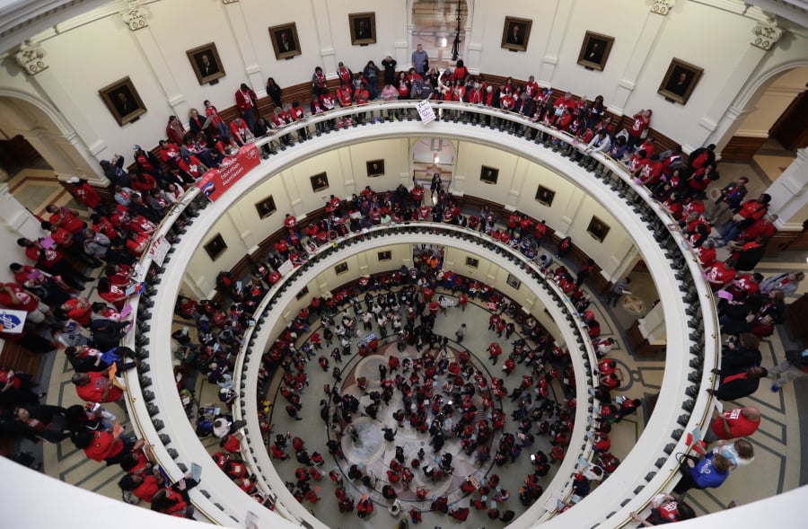 In this March 11, 2019, photo, Educators attending a rally to support funding for public schools in Texas fill the rotunda of the state Capitol in Austin, Texas. Cost-cutting states are trying to keep schools happy as teacher unrest over low pay and overcrowded classrooms continues. But pressure from voters is forcing states to put more money on the table as much as much as picket lines.