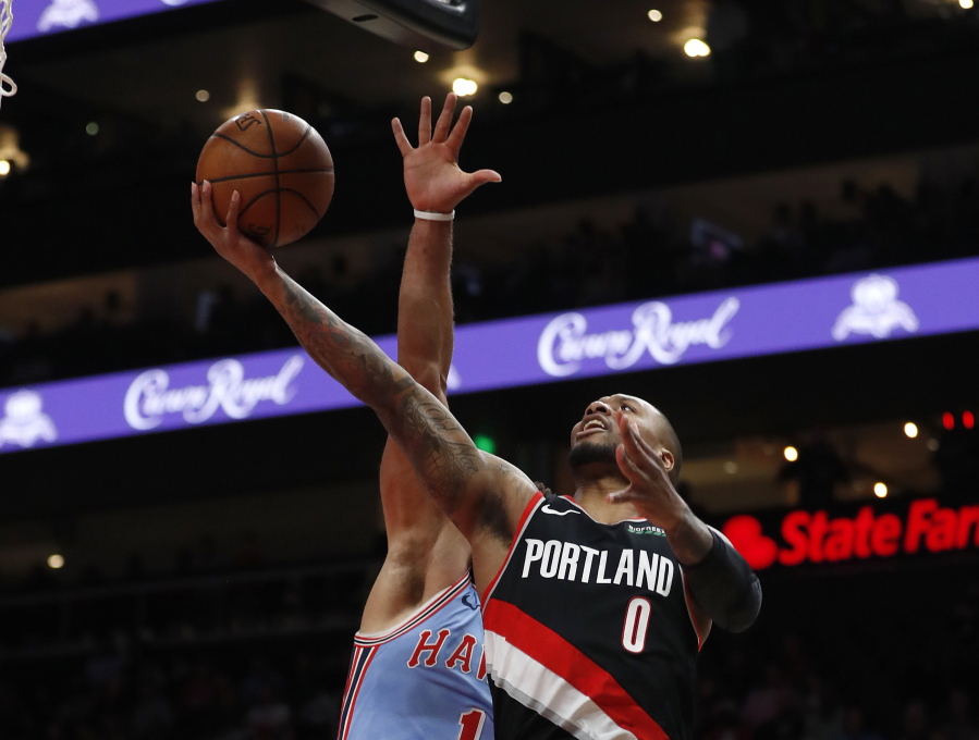 Portland Trail Blazers guard Damian Lillard (0) goes in for a basket in the first half of an NBA basketball game against the Atlanta Hawks, Friday, March 29, 2019, in Atlanta.