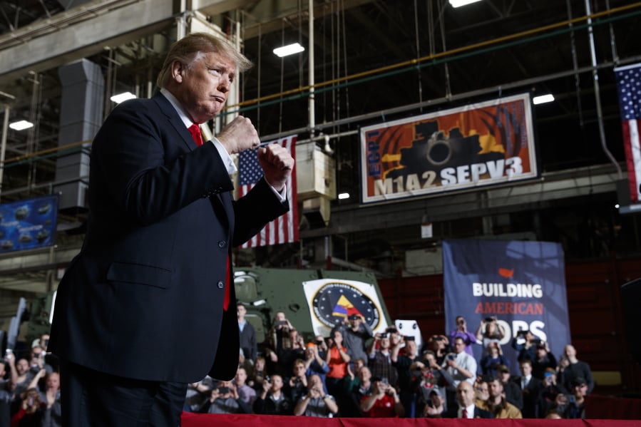 President Donald Trump pumps his fists as he arrives to deliver remarks at the Lima Army Tank Plant, Wednesday, March 20, 2019, in Lima, Ohio.